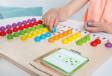 Παιδί που μετράει τις ξύλινες μπαλίτσες του Marbelino 3, αντιστοιχίζοντας ποσότητες με αριθμούς από το 1 έως το 10.