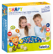 Το πλήρες σετ Beleduc 22471 Shapy με τα 41 ξύλινα πλακίδια σχημάτων, τα 3 ζάρια και το υφασμάτινο ταμπλό.