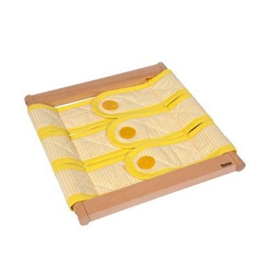 046500 Nienhuis Montessori Πλαίσιο Ντυσίματος με κίτρινο καρό ύφασμα και τρία μεγάλα κίτρινα κουμπιά σε τετράγωνο ξύλινο πλαίσιο.
